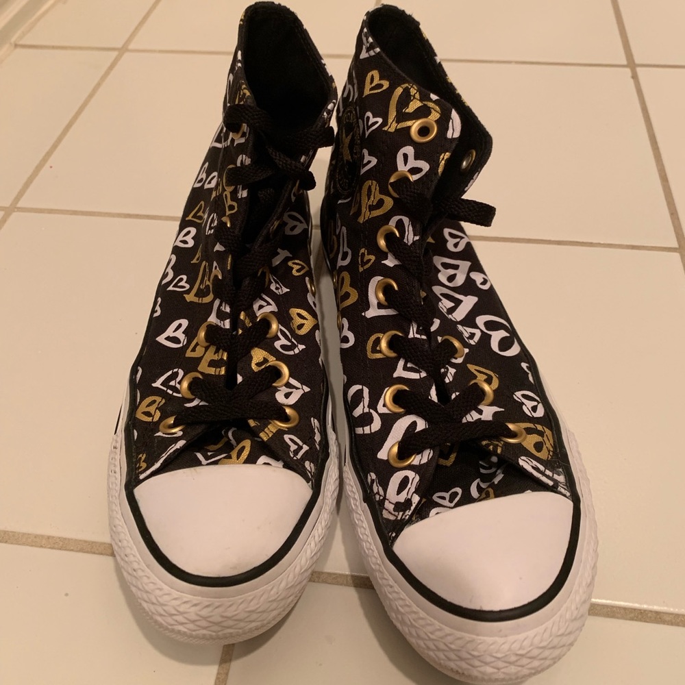Women’s black, white, and gold converse